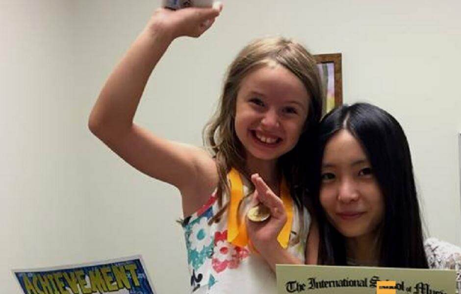 Music Teacher with a student holding a dimploma at International School of Music in Potomac