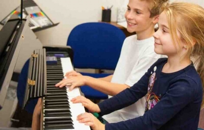 Bethesda students having fun in their piano lesson at International School of Music