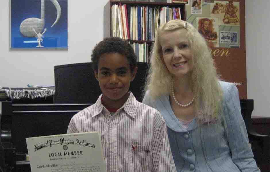 International School of Music piano student holding the Piano Guild Audition Diploma in Bethesda